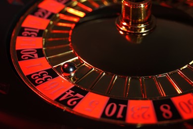 Photo of Closeup view of roulette wheel with ball. Casino game