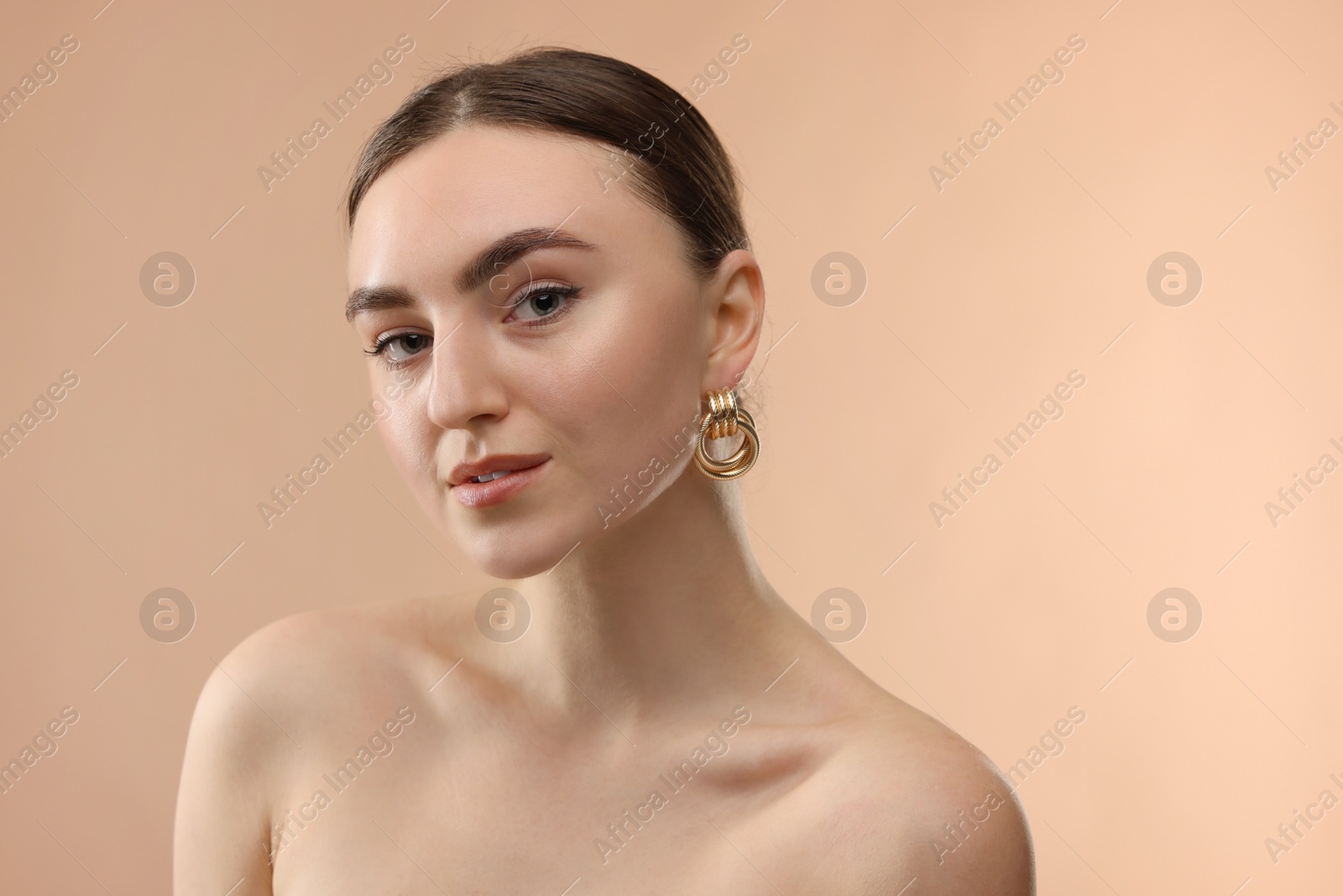 Portrait of beautiful young woman on beige background Photo of Portrait of beautiful young woman on beige background
