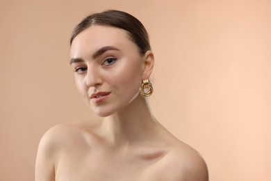 Photo of Portrait of beautiful young woman on beige background