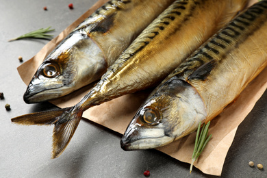 Photo of Tasty smoked fish on grey table, closeup