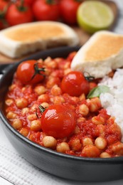 Photo of Delicious chickpea curry with rice on white wooden table, closeup