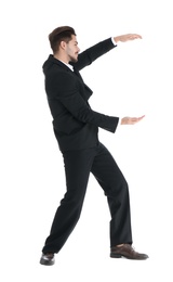 Photo of Young businessman with magnet attracting people on white background