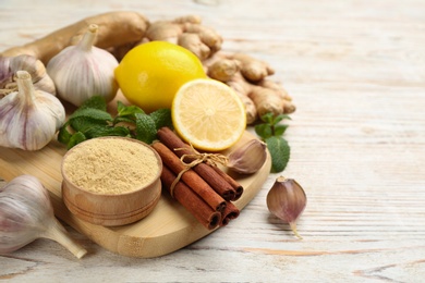 Photo of Different fresh products on light wooden table, space for text. Natural antibiotics