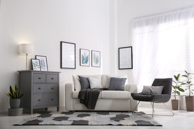 Photo of Modern room interior with grey chest of drawers