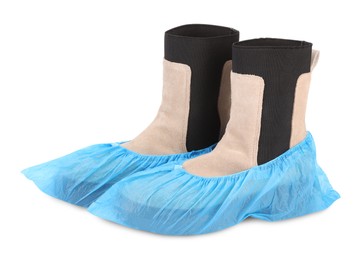 Photo of Women's boots in blue shoe covers isolated on white