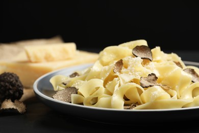 Photo of Tasty tagliatelle with truffle on table, closeup