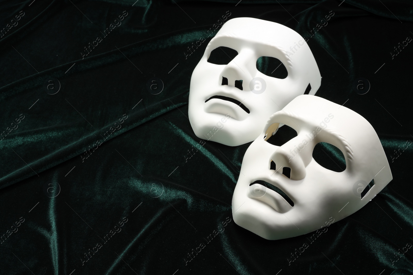 Photo of Theater arts. White mask on green fabric, space for text