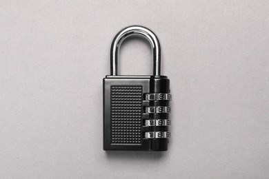 Photo of One steel combination padlock on grey background, top view