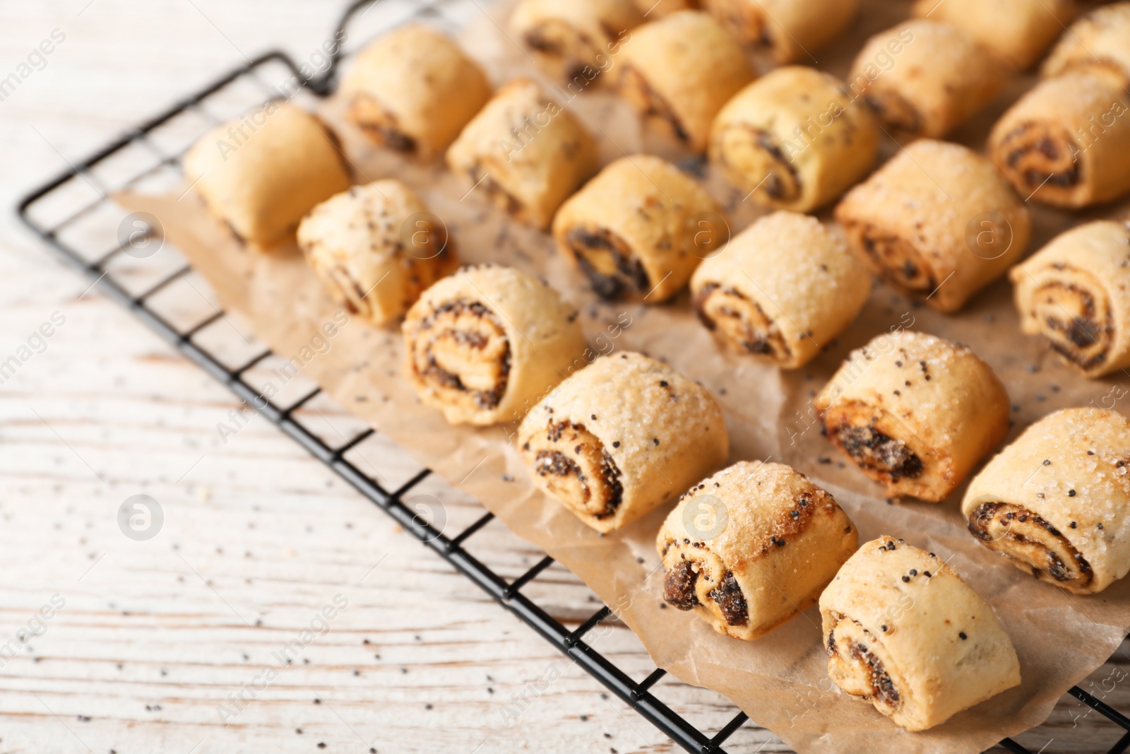 Tasty sweet cookies with poppy seeds on wooden table Photo of Tasty sweet cookies with poppy seeds on wooden table