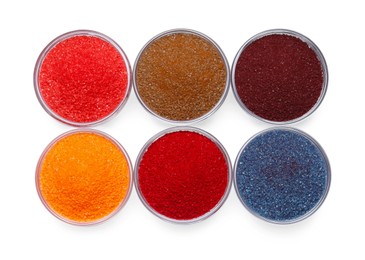 Photo of Glass bowls with different food coloring isolated on white, top view