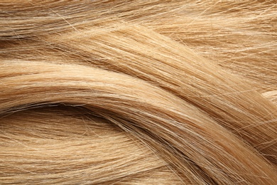 Photo of Texture of healthy blond hair as background, closeup
