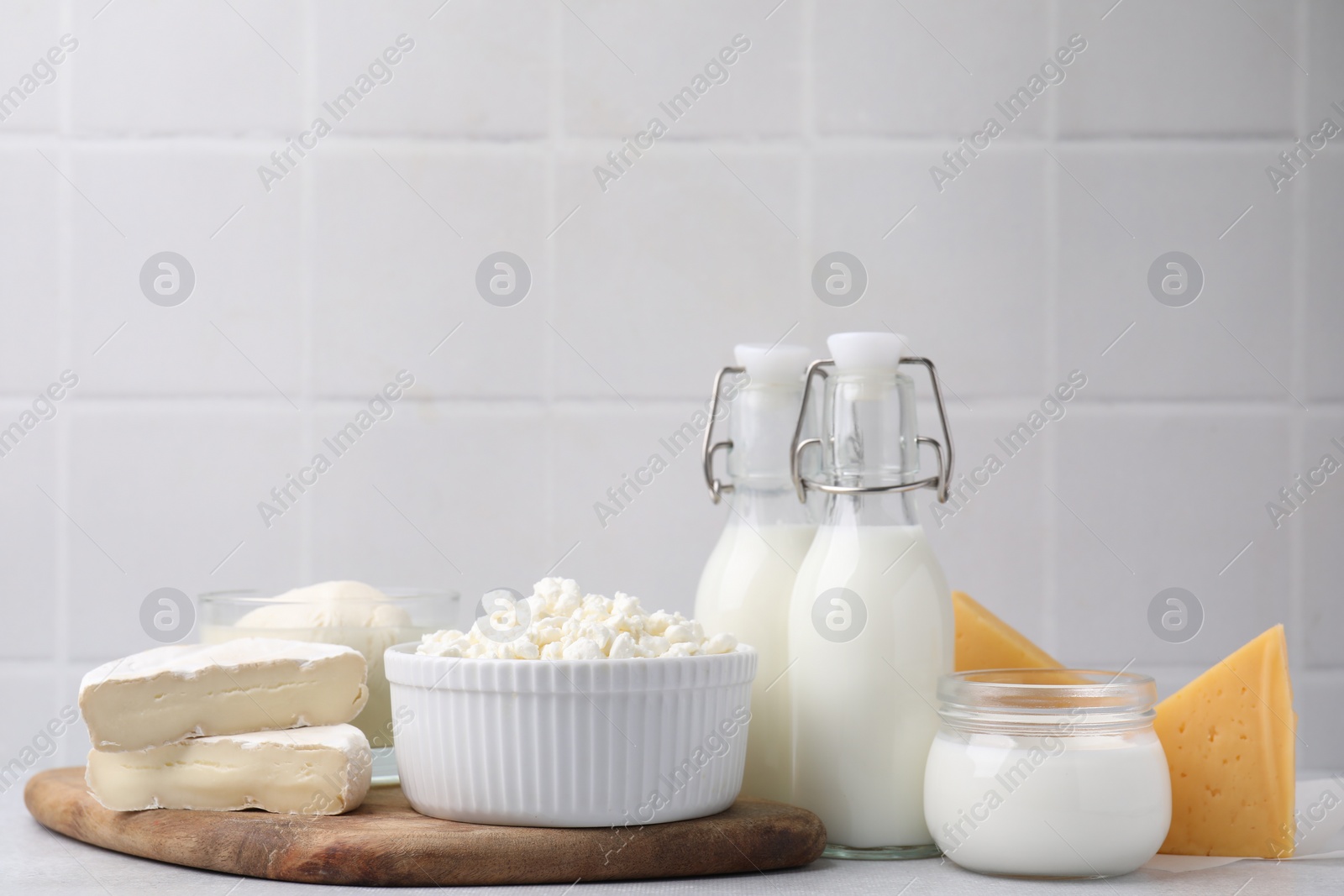 Photo of Different fresh dairy products on light table