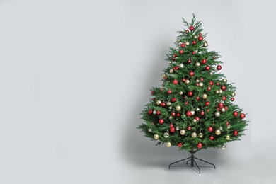 Photo of Beautifully decorated Christmas tree on white background