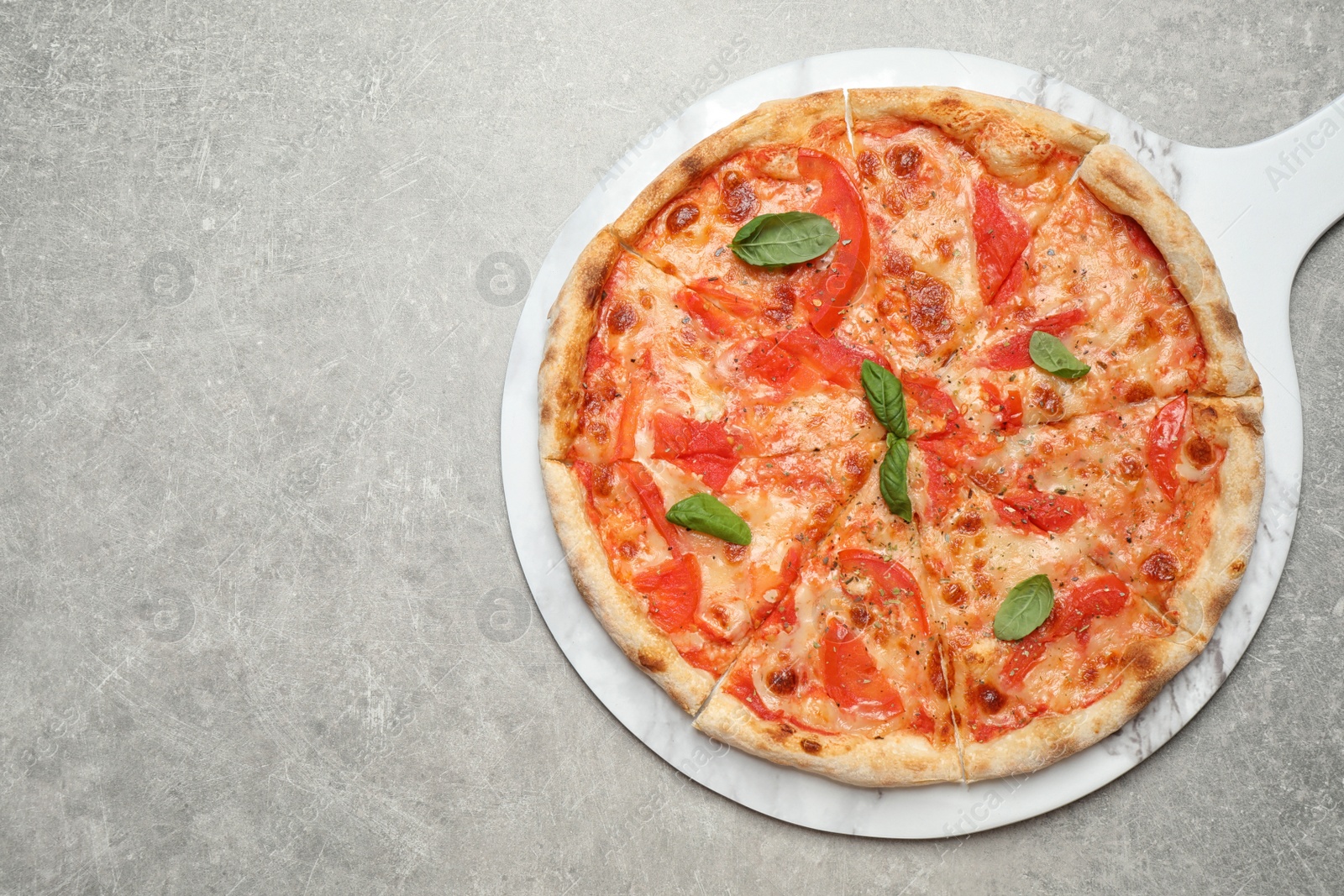 Photo of Delicious pizza Margherita on light grey table, top view. Space for text