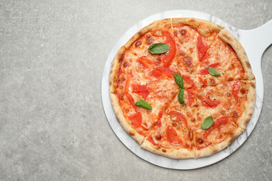 Delicious pizza Margherita on light grey table, top view. Space for text