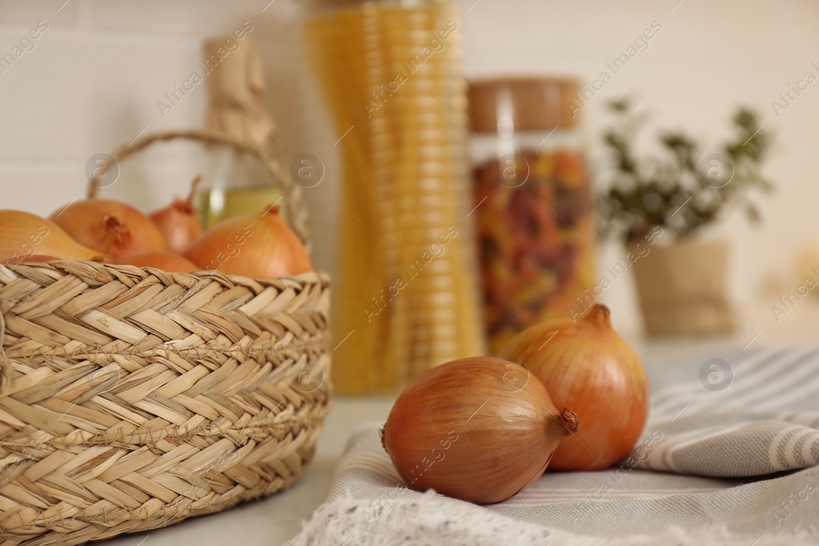 Photo of Fresh onions on countertop in modern kitchen, closeup