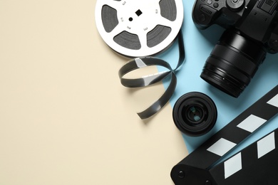 Photo of Flat lay composition with camera and video production equipment on color background. Space for text