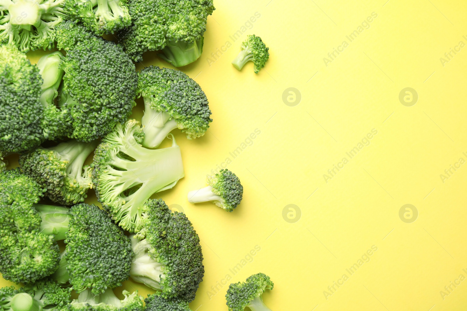 Photo of Flat lay composition with fresh green broccoli on color background. Space for text