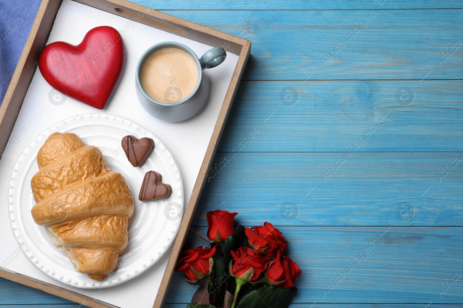 Photo of Romantic breakfast and roses on blue wooden table, flat lay with space for text. Valentine's day celebration