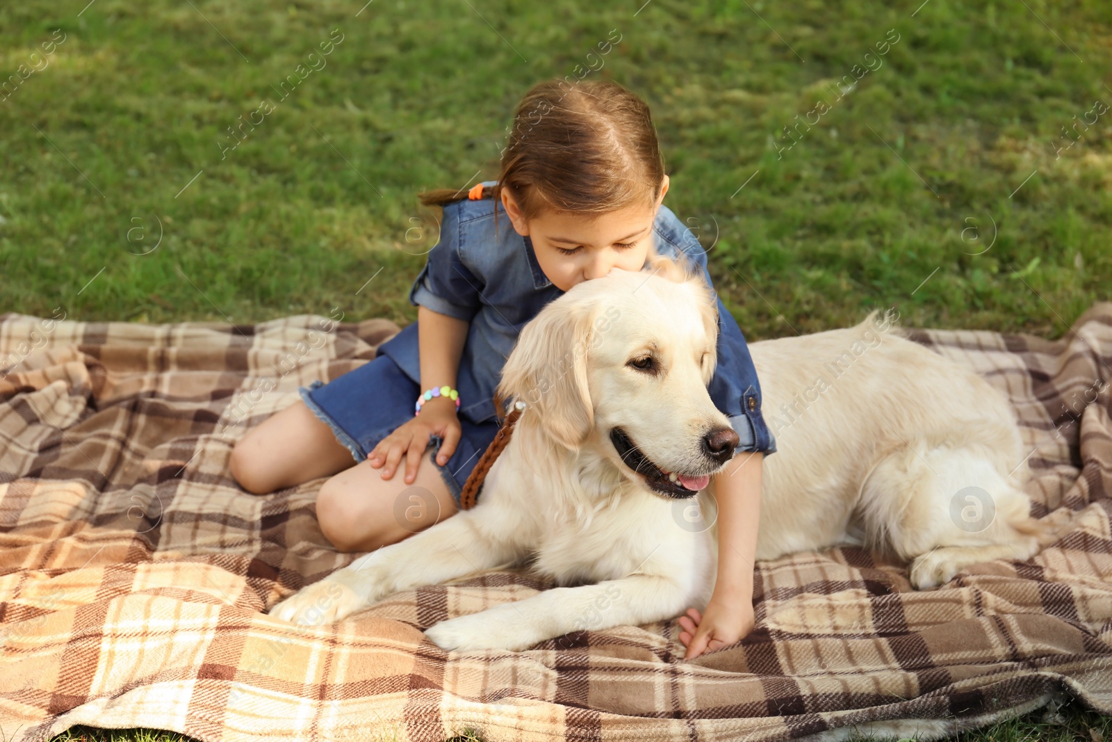 Photo of Cute little child with his pet in green park