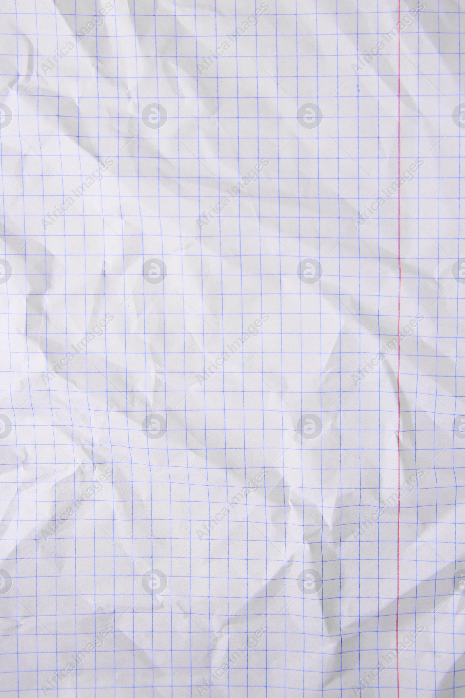 Photo of Sheet of crumpled checkered paper as background, top view