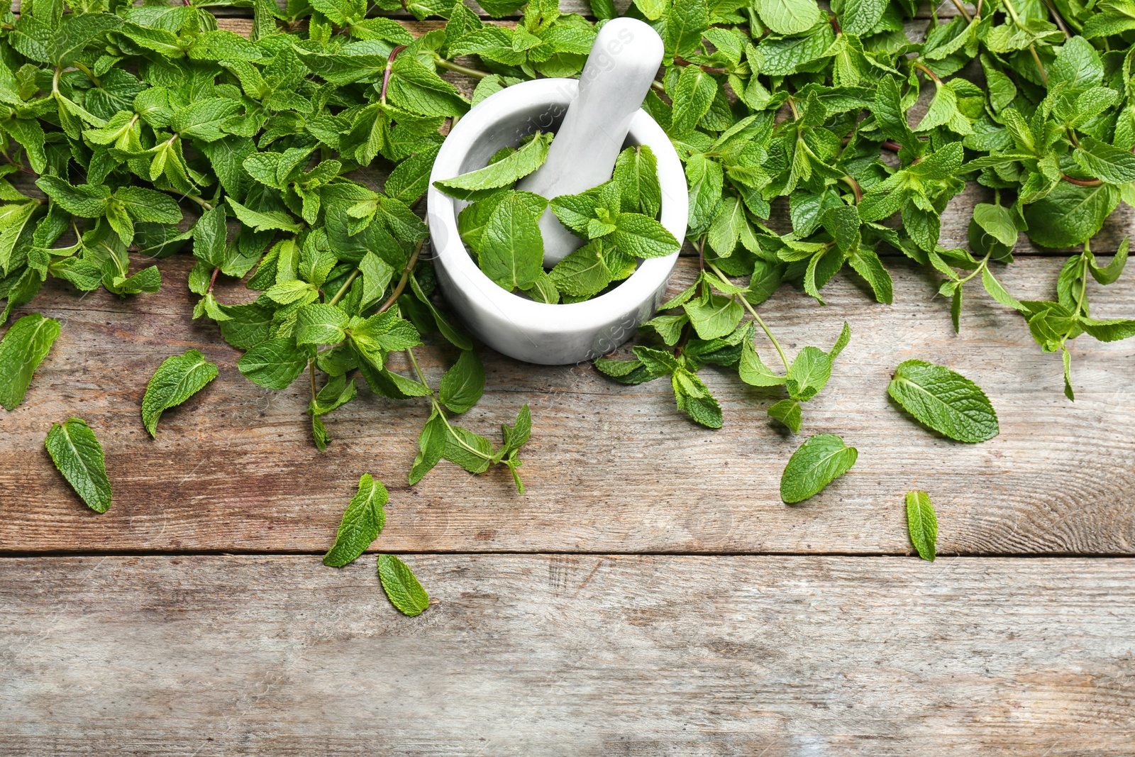 Photo of Flat lay composition with mint and mortar on wooden background