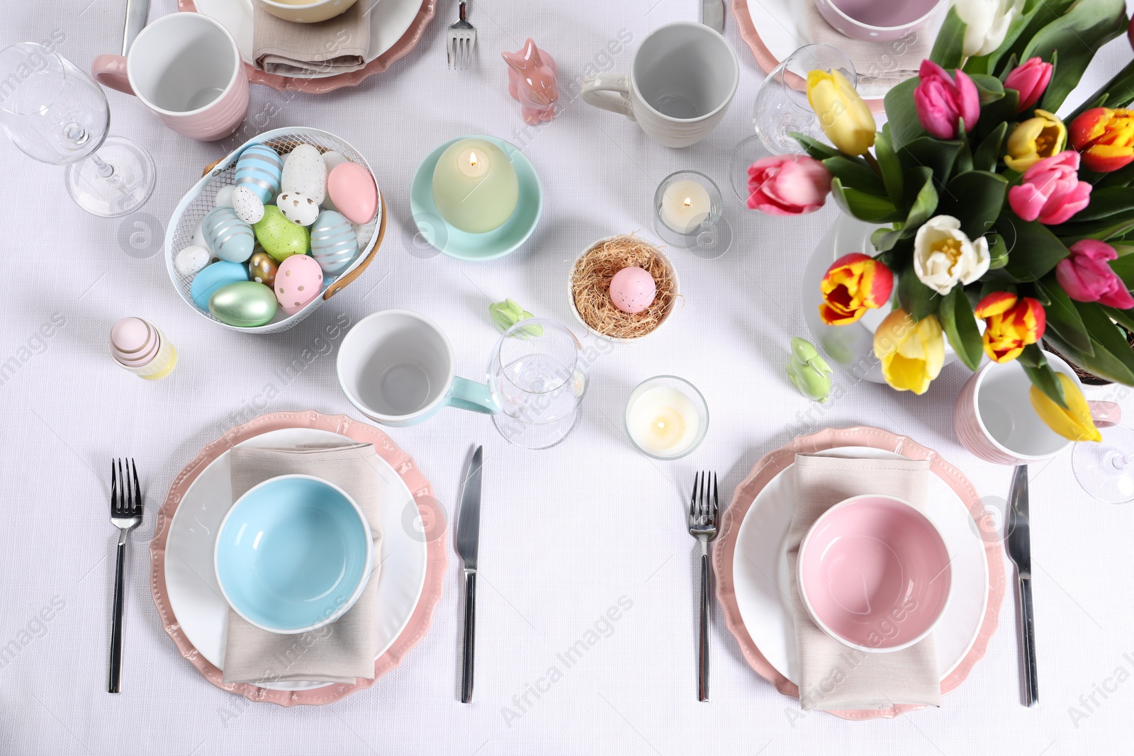 Photo of Festive table setting with beautiful flowers, flat lay. Easter celebration