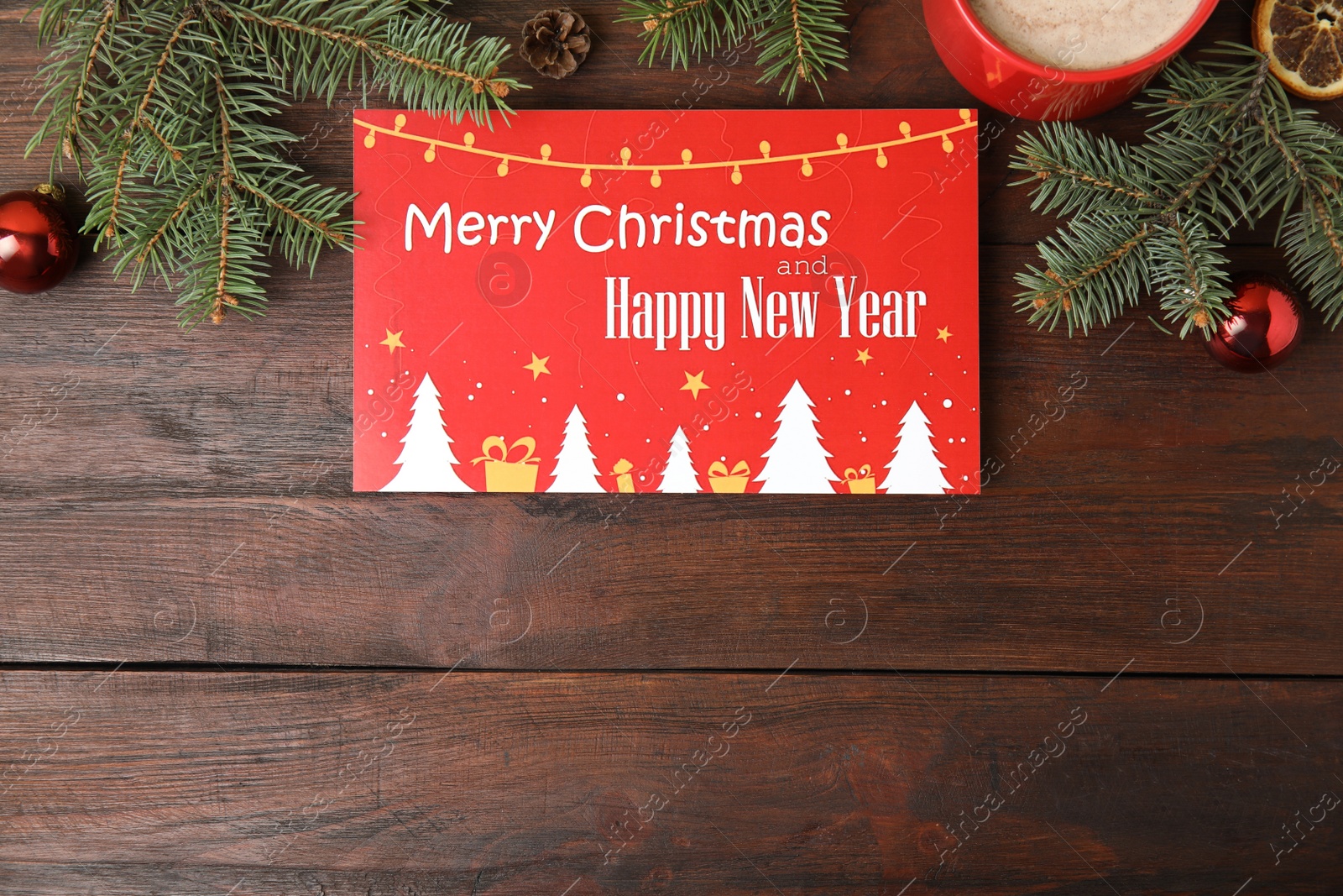 Photo of Flat lay composition with greeting card and Christmas decor on wooden background, space for text