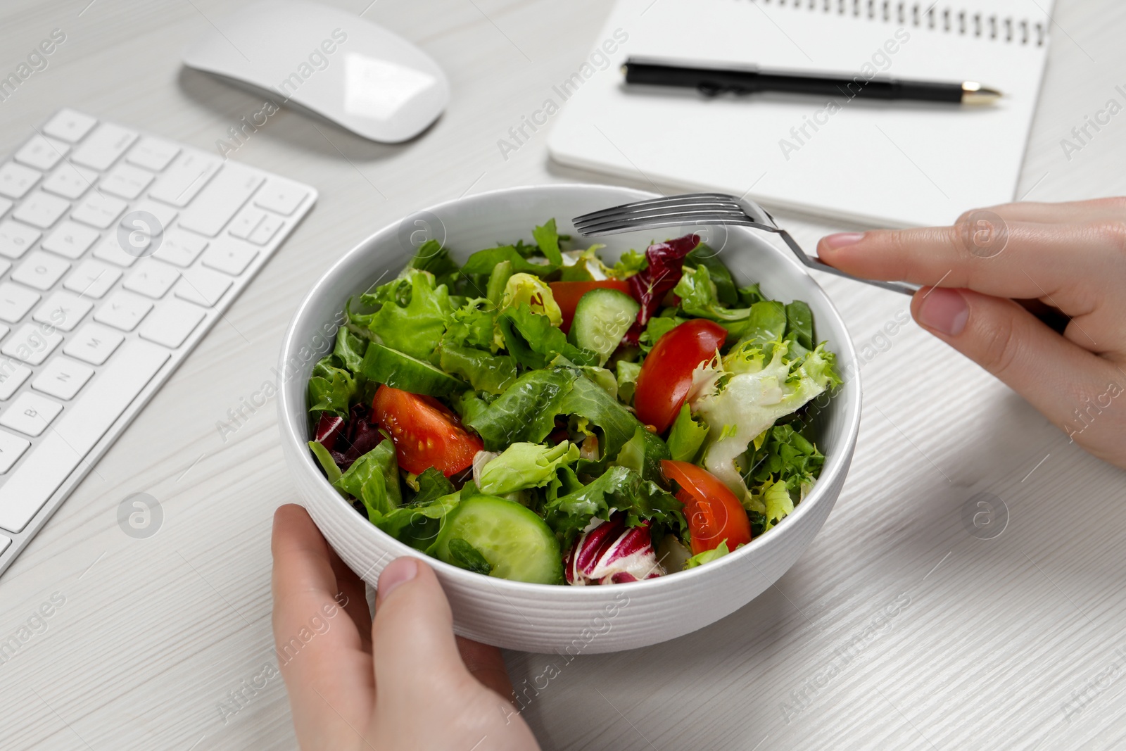 Photo of Office employee having business lunch at workplace, closeup