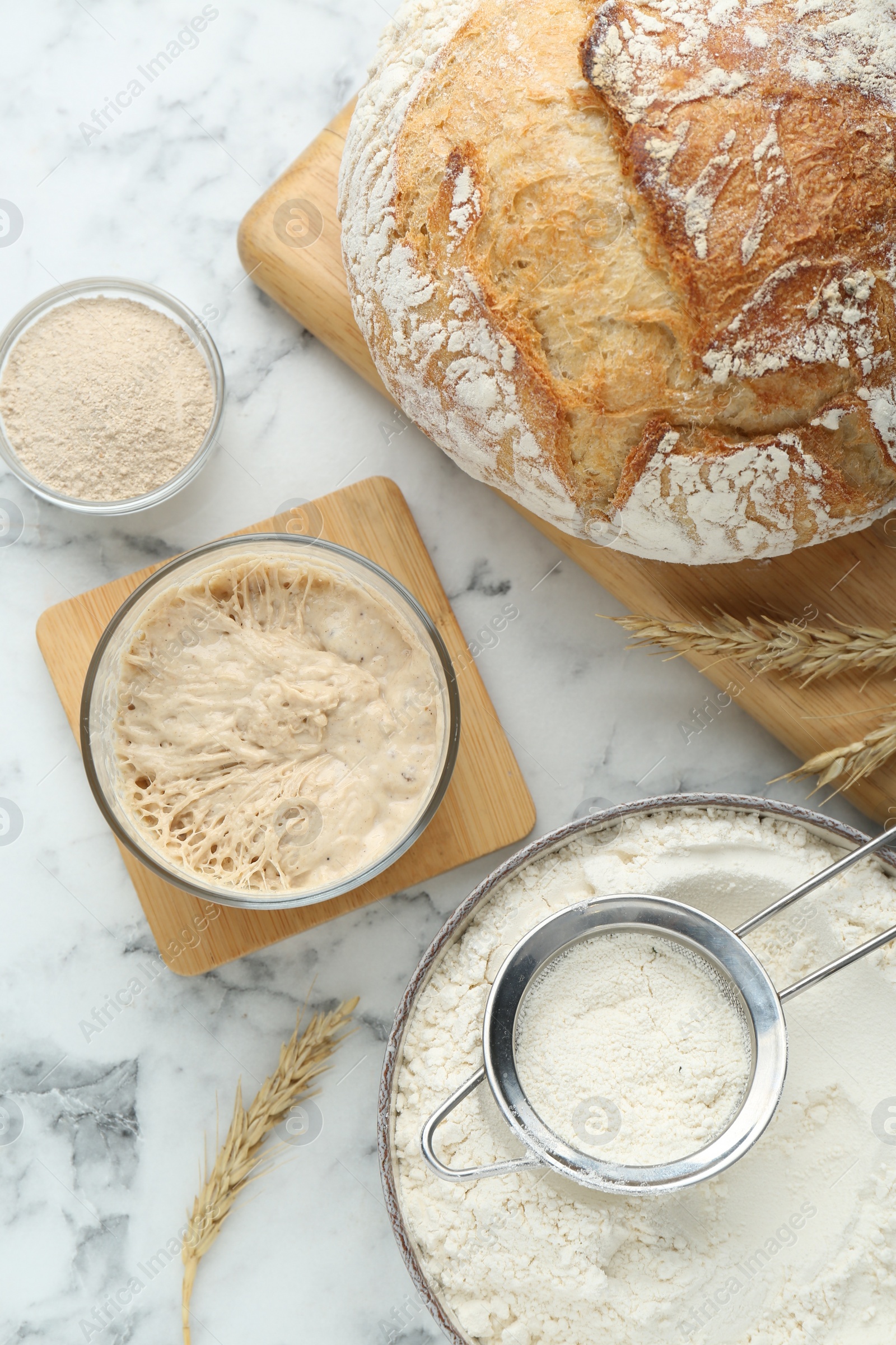Photo of Flat lay composition with sourdough on white marble table