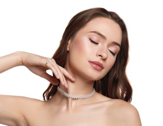 Young woman wearing elegant pearl jewelry on white background