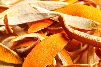 Photo of Many dry orange peels on white table, closeup