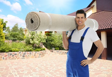 Image of Worker with rolled carpet outdoors on sunny day