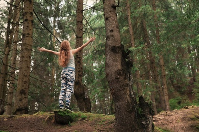 Photo of Woman on walk in beautiful coniferous forest