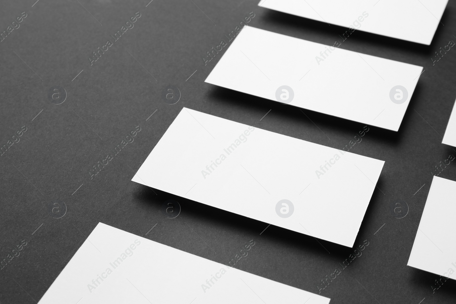 Photo of Blank business cards on black background, closeup. Mockup for design