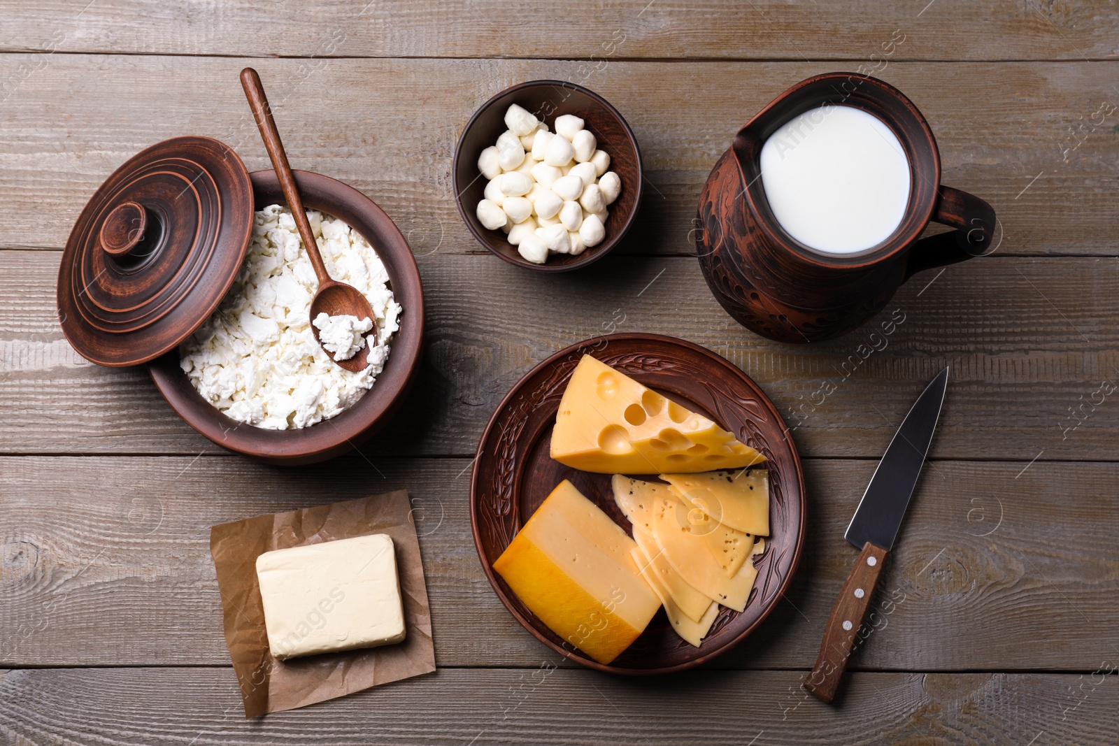 Photo of Flat lay composition with dairy products and clay dishware on grey wooden table