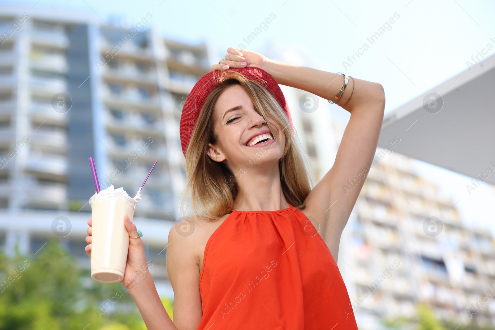 Photo of Beautiful woman with tasty drink on city street