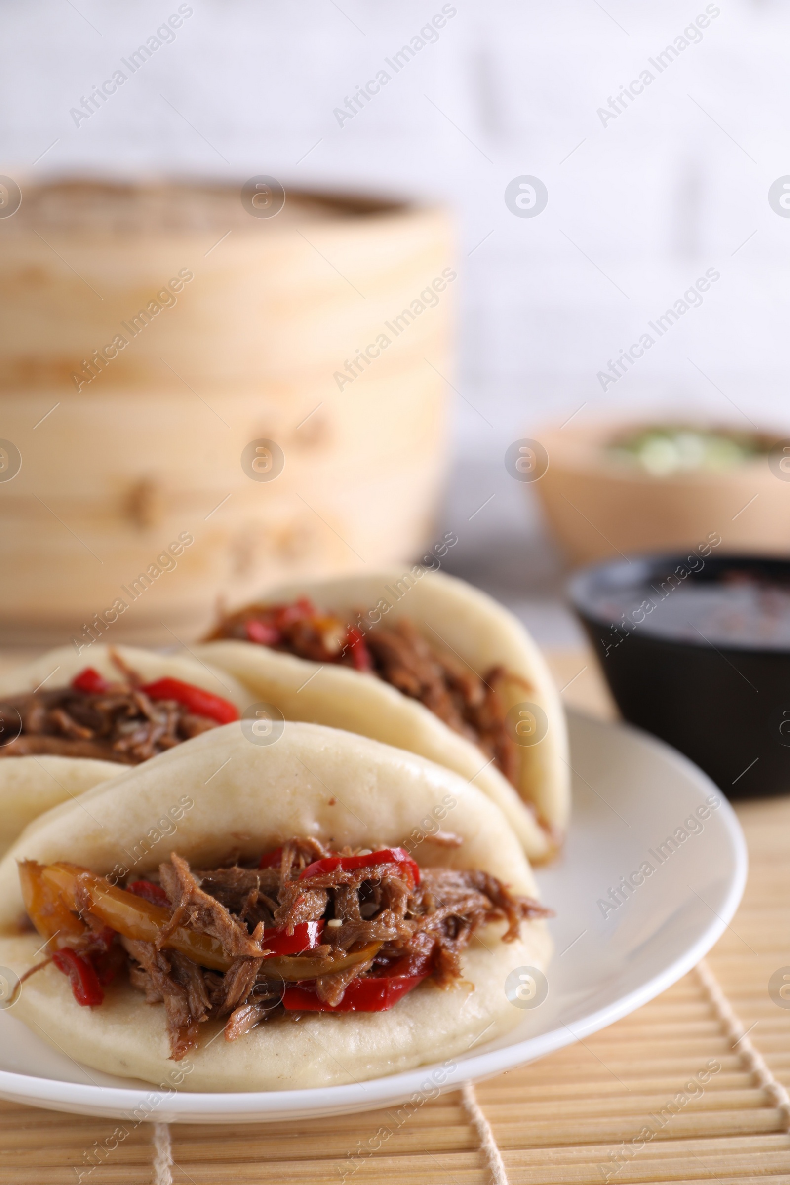 Photo of Plate with delicious gua bao (pork belly buns) on table, closeup