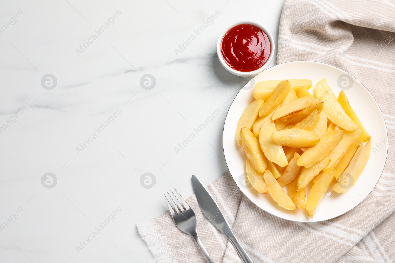 Photo of Plate with tasty baked potato wedges and sauce on white marble table, flat lay. Space for text