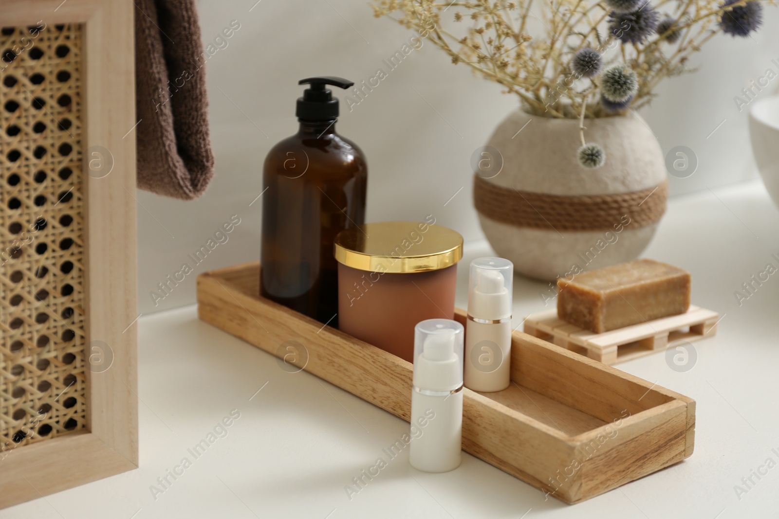 Photo of Personal hygiene products and toiletries on table in bathroom