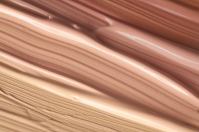 Image of Different shades of liquid foundation as background, closeup