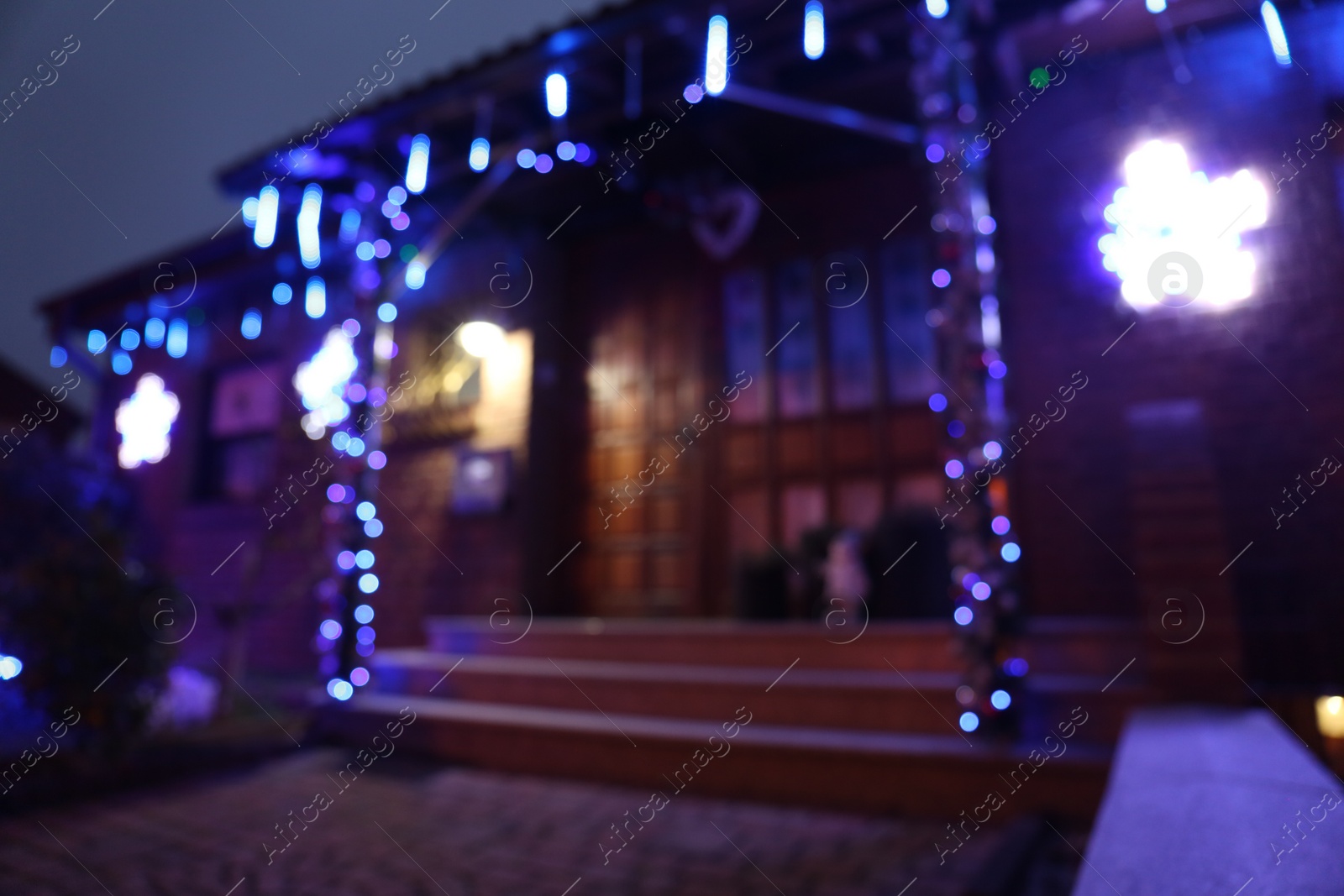 Photo of Blurred view of beautiful house decorated for Christmas, bokeh effect. Festive decor