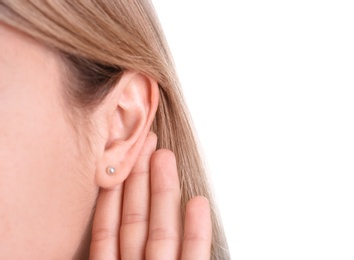 Photo of Young woman with hearing problem on white background, closeup