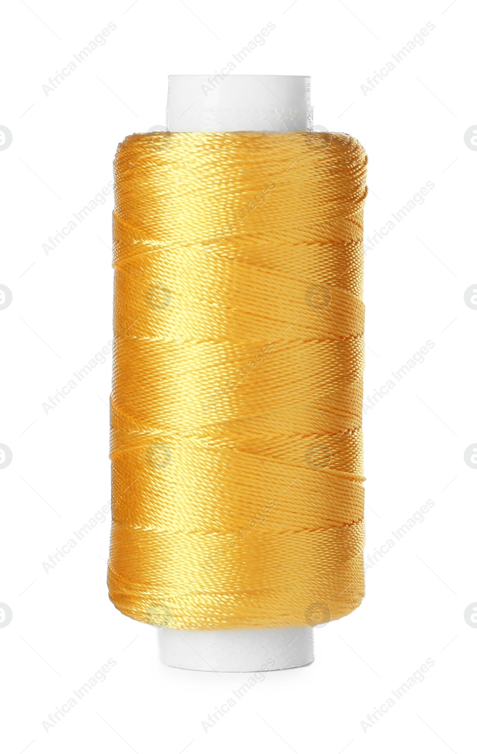 Photo of Spool of yellow sewing thread isolated on white