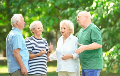 Photo of Elderly people spending time together in park