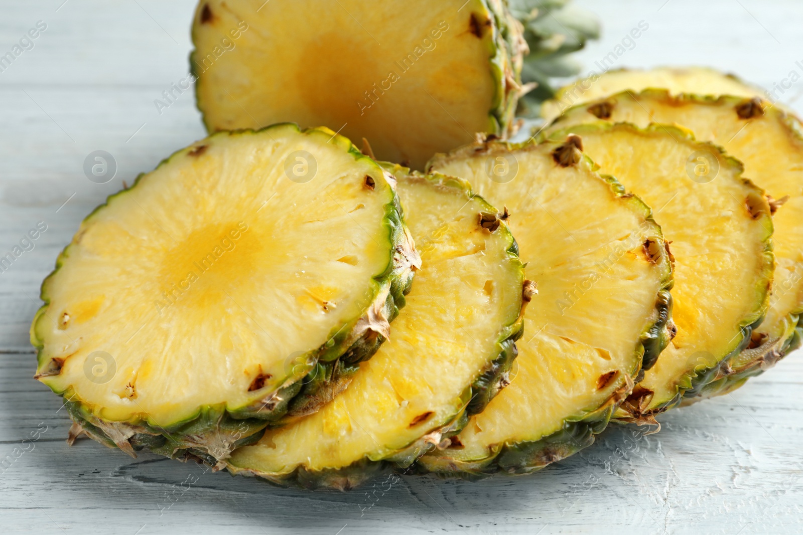 Photo of Fresh sliced pineapple on table, closeup