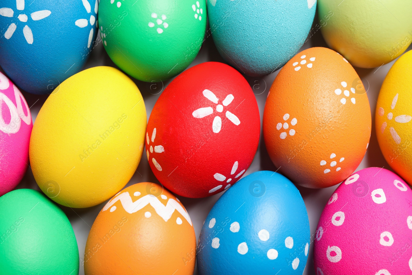 Photo of Colorful Easter eggs with different patterns as background, top view