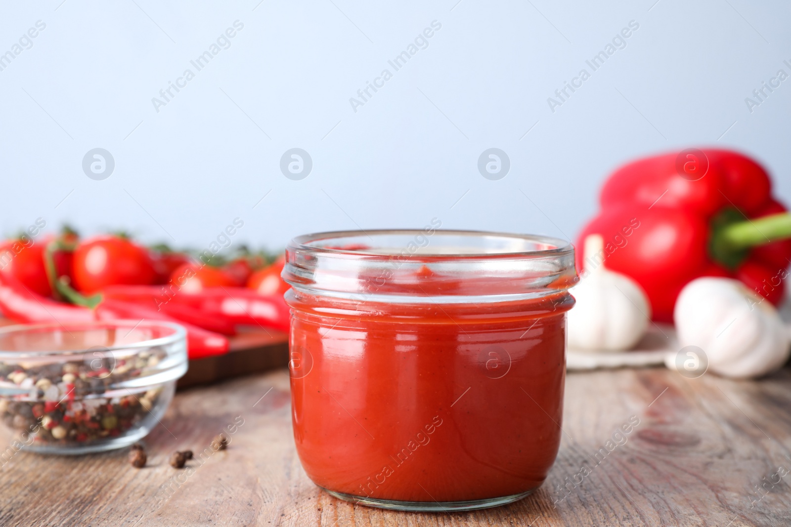 Photo of Delicious fresh tomato sauce on wooden table, closeup