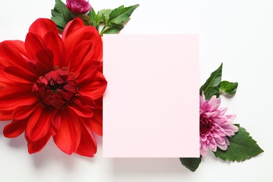 Photo of Flat lay composition with beautiful dahlia flowers and blank card on white background