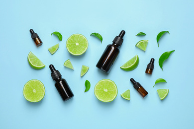 Photo of Flat lay composition with lime essential oil on light blue background